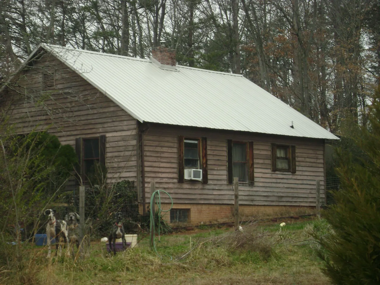 White metal roof on an old wood sided farmhouse, from a Metal Roof Installation job in Miamitown